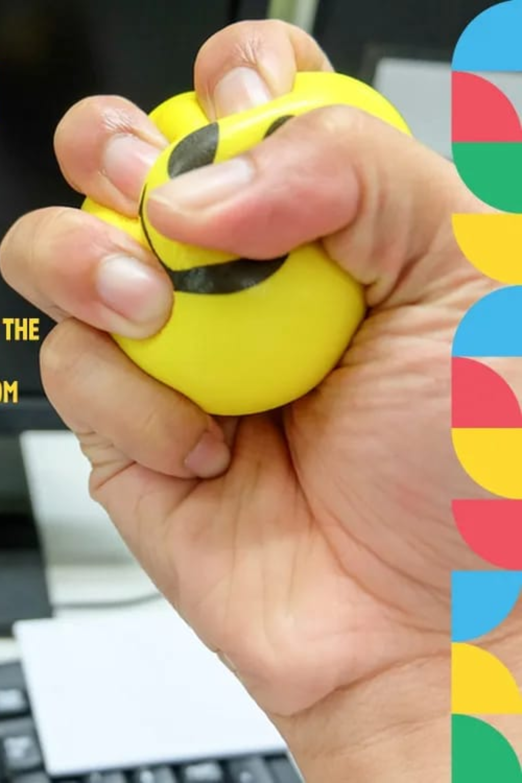 Customized anti-stress ball being squeezed at desk – available in round, square, heart shapes and multiple colors